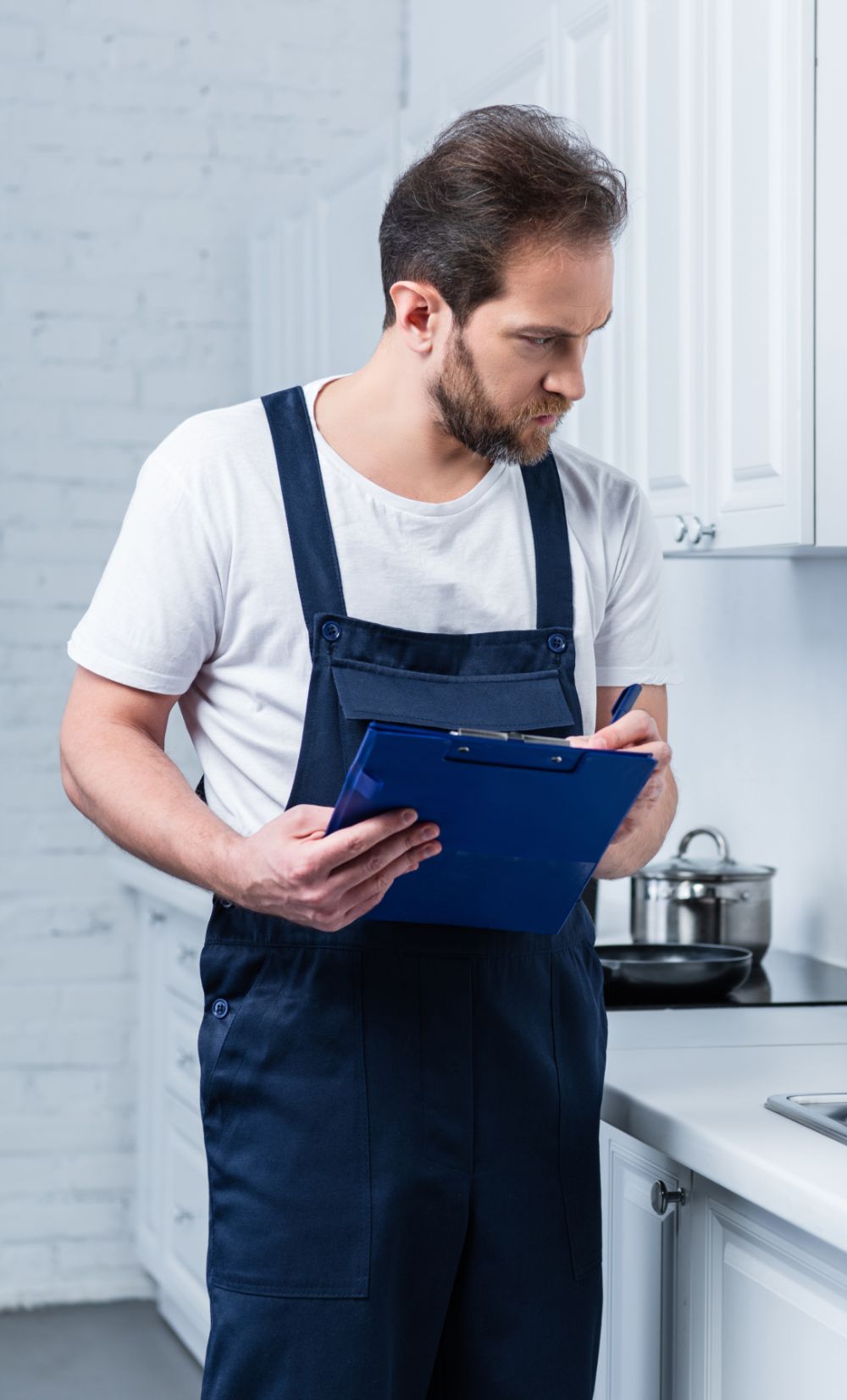 serious adult repairman in working overall writing xfl3mnz 1.jpg